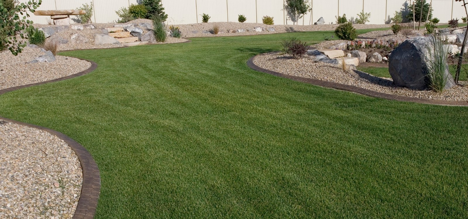 Drought-tolerant front yard landscaping with native plants and decorative rocks in a Camarillo, CA residential property by Goers Landscaping